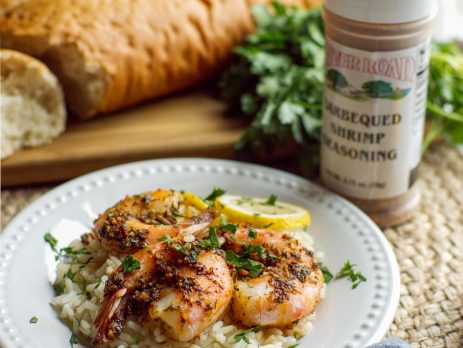 Freshly prepared Barbecued Shrimp on a bed of white rice with French bread created with River Road Brand New Orleans-style Barbecued Shrimp Seasoning.